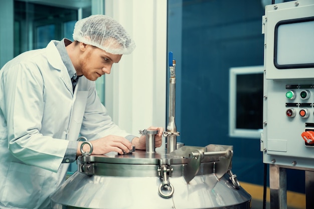 Portrait of a scientist apothecary extracting cannabis oil in laboratory