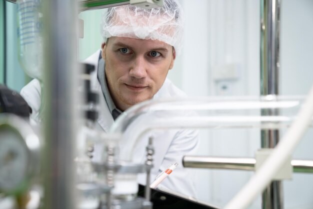 Portrait of a scientist apothecary extracting cannabis oil in laboratory