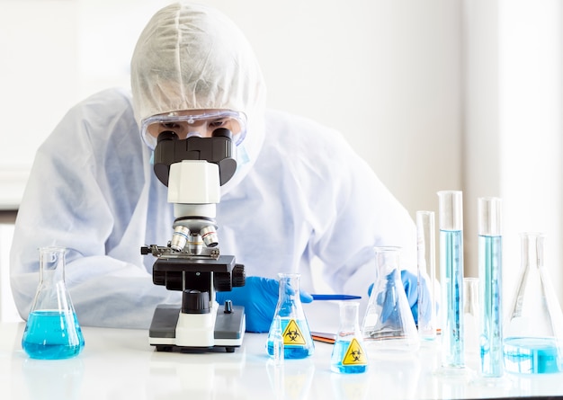 Portrait of scientist looking into the microscope.