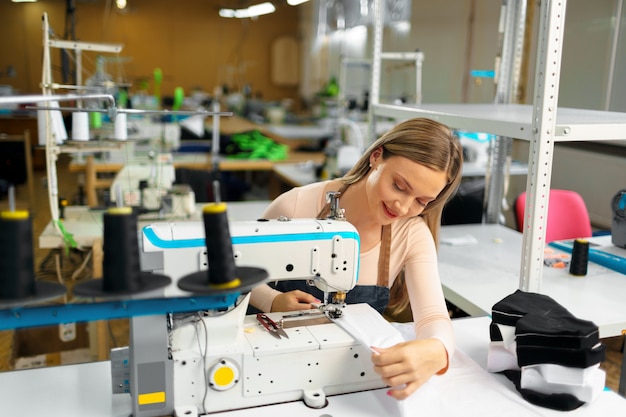 Portrait of seamstress working with sewing machine