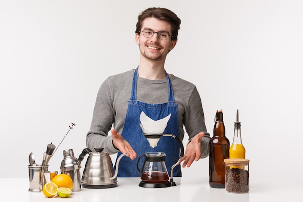 Portrait of self-assured friendly young caucasian man in apron