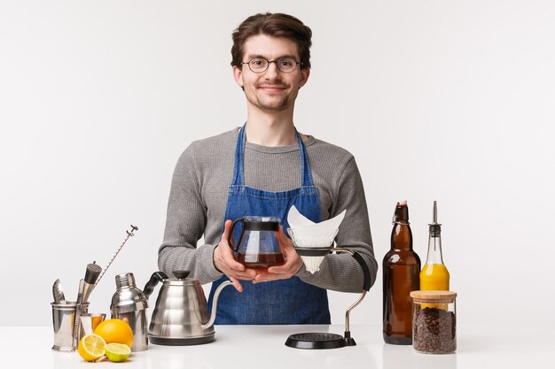 Portrait of self-assured friendly young caucasian man in apron