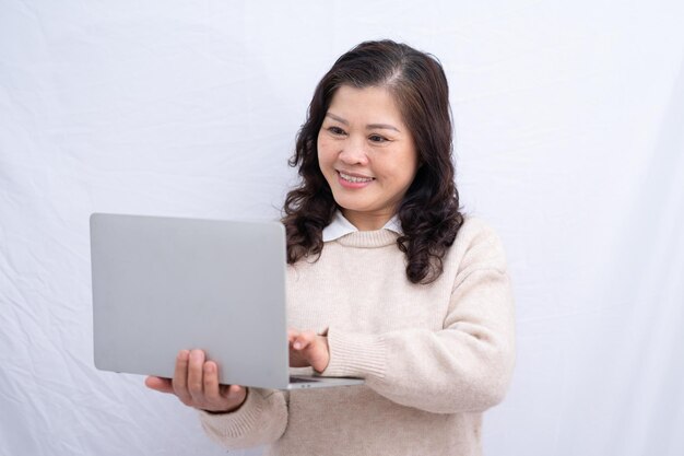 Portrait of senior Asian woman on white background