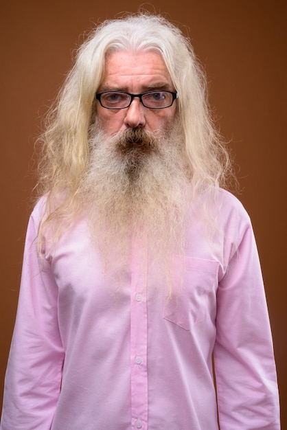 Portrait of senior bearded man wearing pink shirt