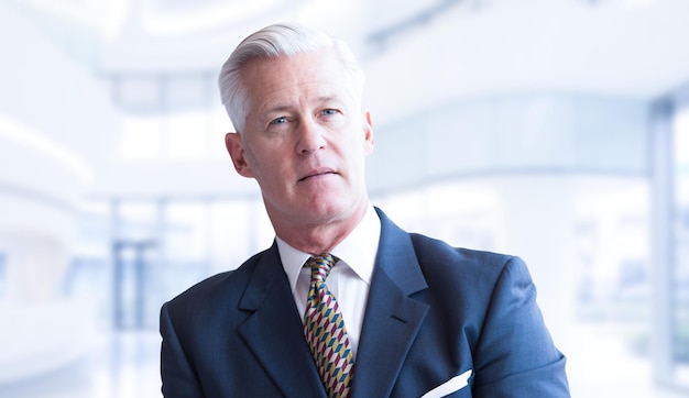 Portrait of senior businessman in front of his modern office