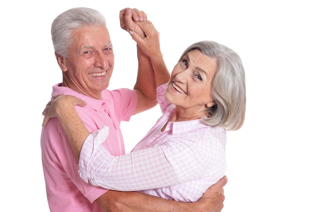 Portrait of senior couple dancing isolated on white background