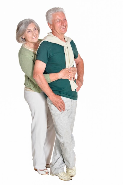 Portrait of senior couple embracing isolated