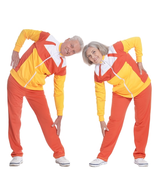 Portrait of Senior Couple Exercising On White Background