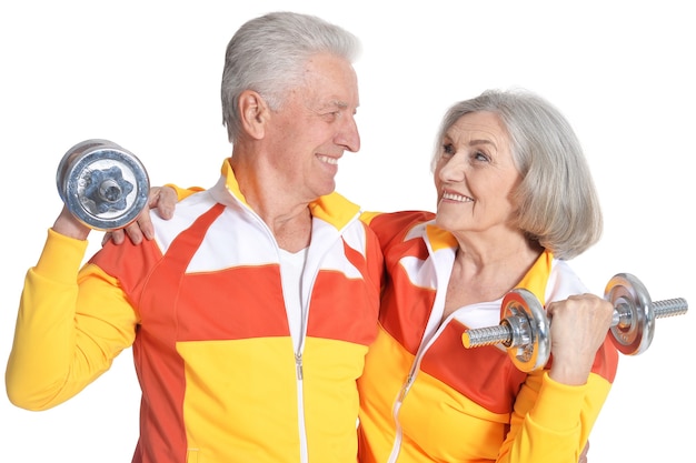 Portrait of Senior Couple Exercising On White Background