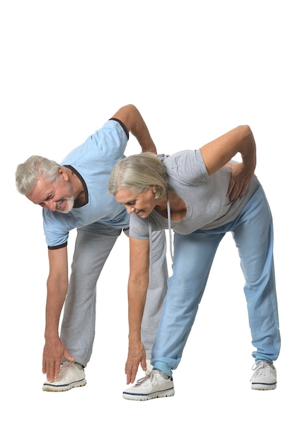 Photo portrait of senior couple exercising on white background