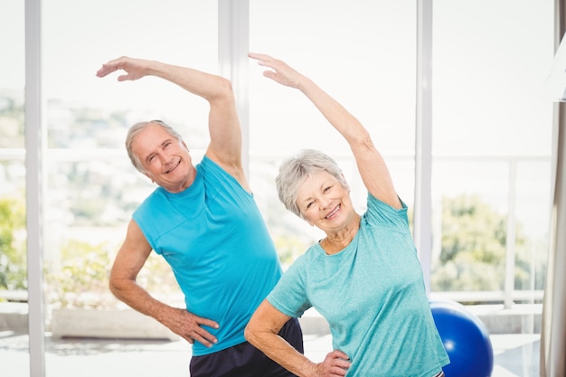 Portrait of senior couple exercising