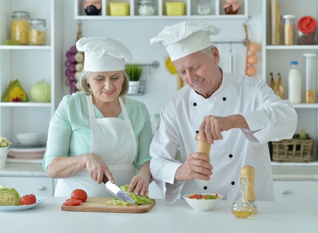 Portrait of a senior couple at kitchen  cooking