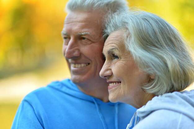 Portrait of a senior couple resting at autumn park