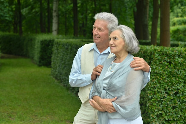 Portrait of a senior couple resting at autumn park