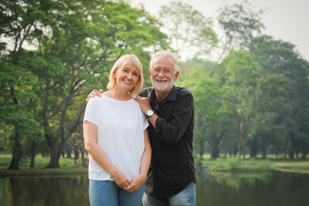 Portrait of Senior couple retirement Man and woman happy in park together 