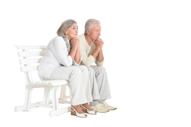 portrait of senior couple sitting on bench