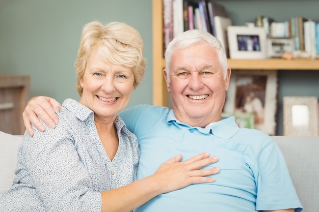 Portrait of senior couple smiling while hugging