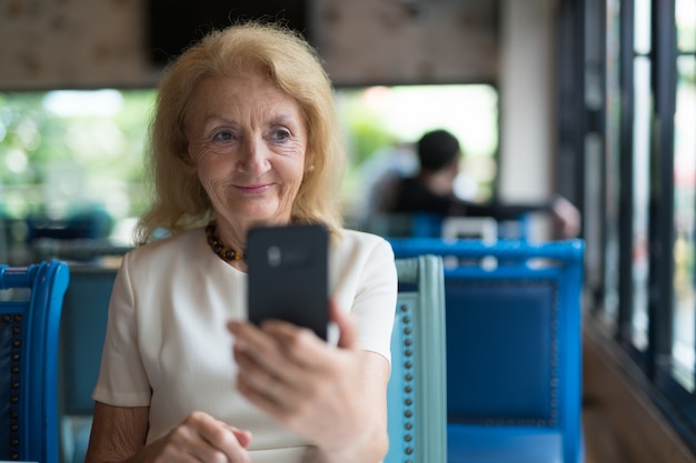 portrait Of Senior Elderly Woman Using Mobile Phone