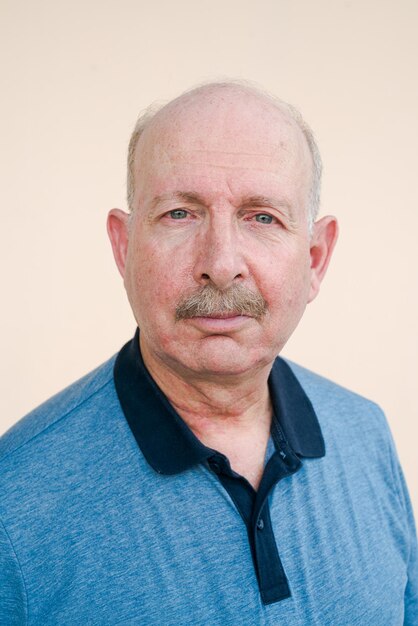 Portrait of senior man against white background