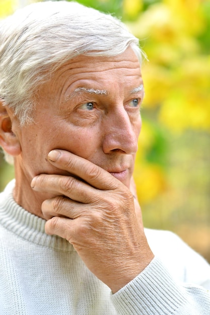 Portrait of senior man in autumn park