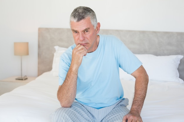 Portrait of senior man on bed