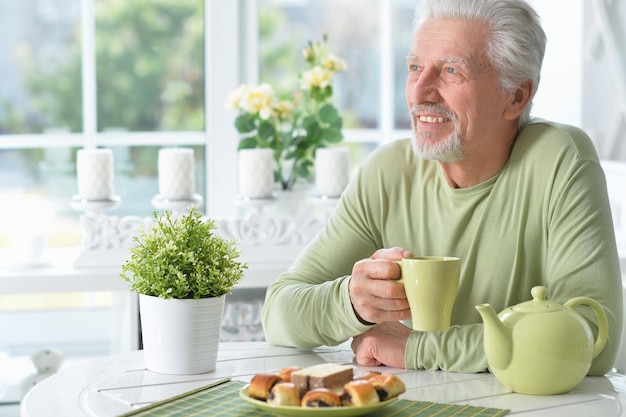 Portrait of senior man drinking tea at home