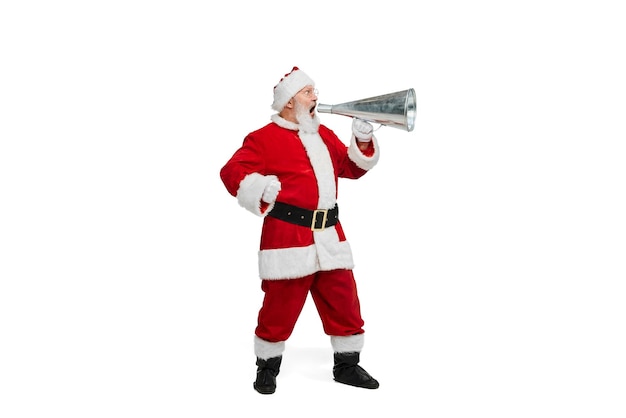 Portrait of senior man in image of santa claus shouting in megaphone isolated over white background