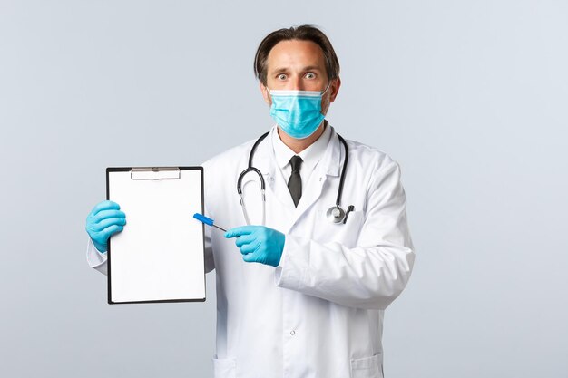 Portrait of senior man standing against white background