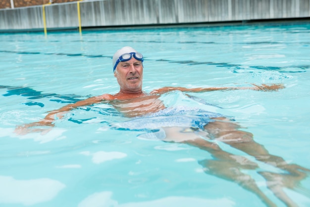 Portrait of senior man swimming in pool