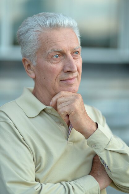 Portrait of senior man thinking about something outdoor