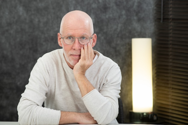 Portrait of a senior man with beard and glasses