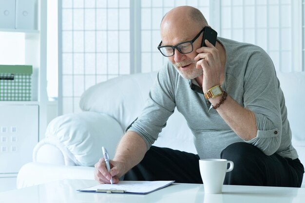 Portrait of a senior man with phone