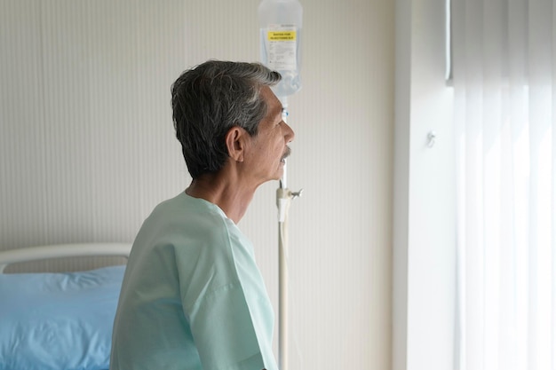 Portrait of senior patient lying on bed in hospital healthcare and medical concept