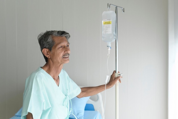 Portrait of senior patient lying on bed in hospital healthcare and medical concept