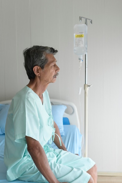 Portrait of senior patient lying on bed in hospital healthcare and medical concept