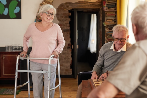 Portrait of senior people enjoying activities in cozy nursing home copy space