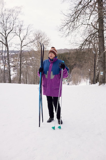 Portrait of a senior skier in a winter forest