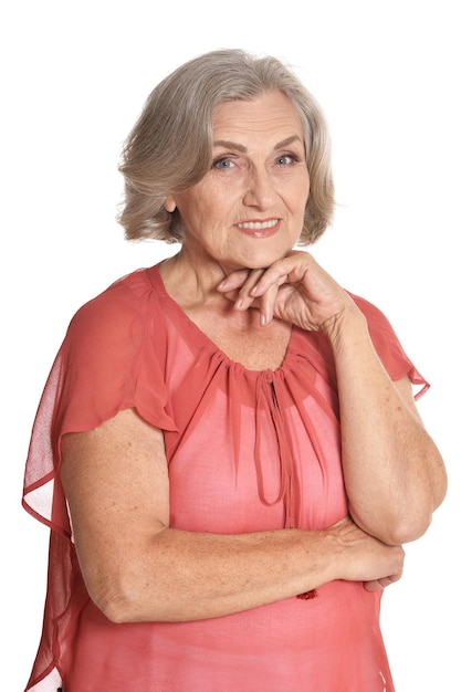 Portrait of senior woman in blue blouse posing isolated on white background