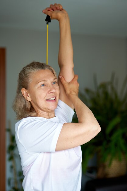 Portrait of senior woman exercise in for sports at home.