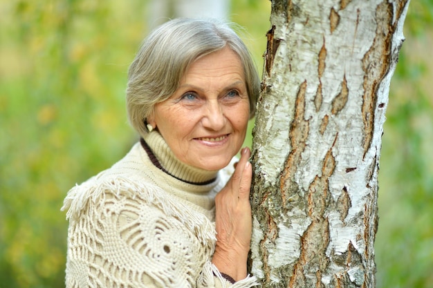 Portrait of senior woman posing in forest