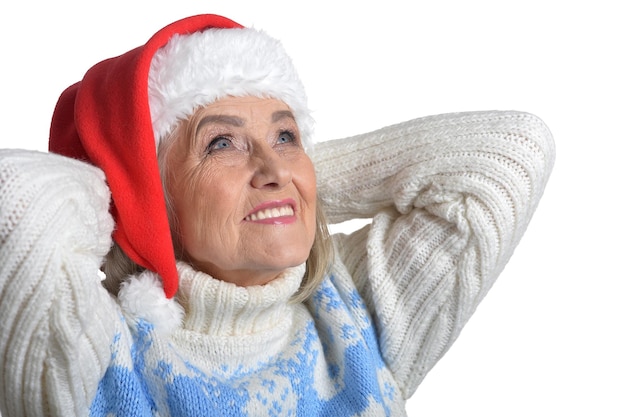 Portrait of senior woman in Santa hat isolated on white background