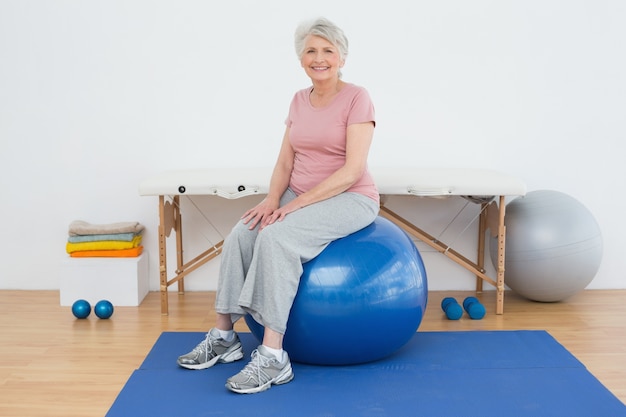 Portrait of a senior woman sitting on fitness ball