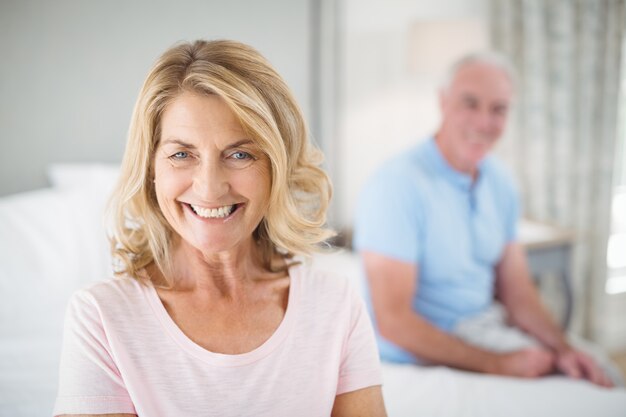 Portrait of senior woman smiling in bedroom