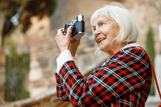 Portrait of senior woman smiling in city