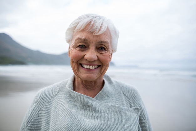 Portrait of senior woman standing on the beach