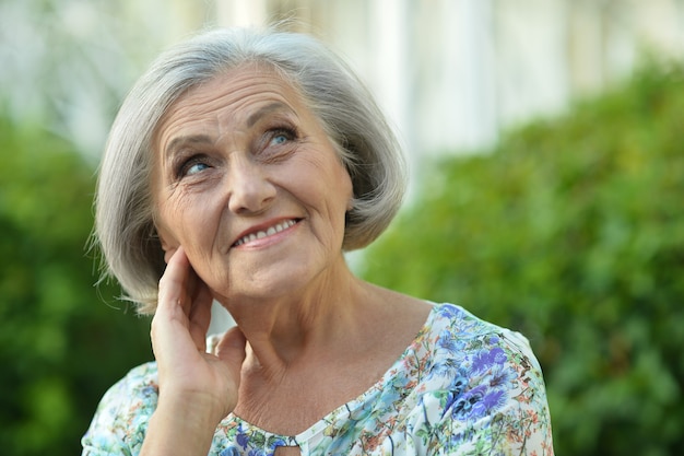 Portrait of a senior woman in summer park