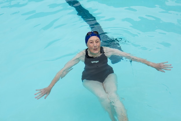 Portrait of senior woman swimming in pool