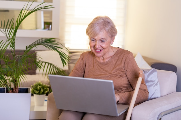 Portrait of senior woman using her laptop