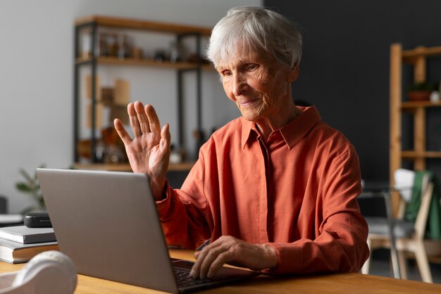 Portrait of senior woman using laptop device at home