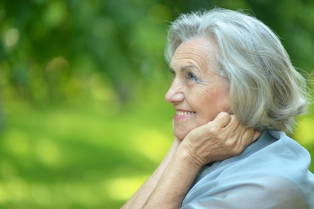 Portrait of a senior woman on a walk in park in spring